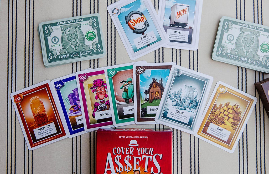 Landscape Photo of Board Game Representing The Contents of Cover Your Assets at Grandpa Beck's Games